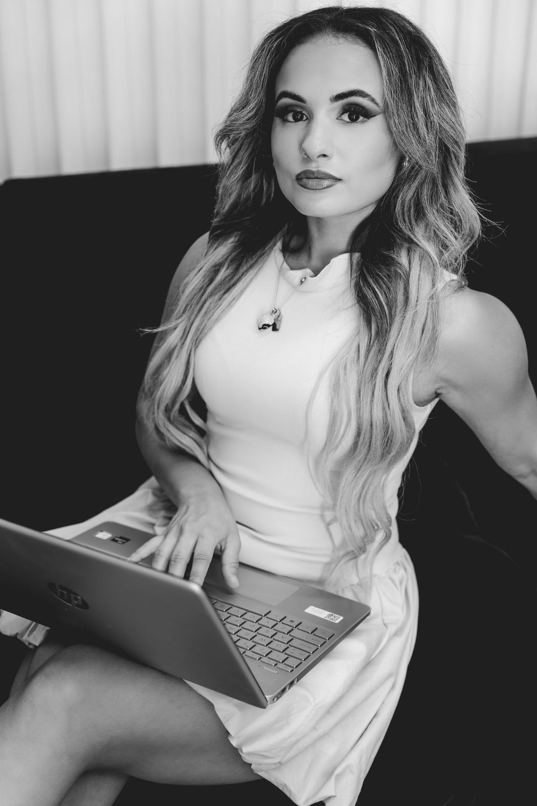 Black and white portrait of a woman working on a laptop