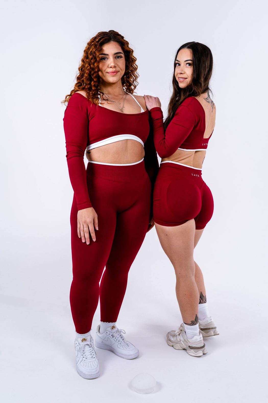 Two women in burgundy activewear