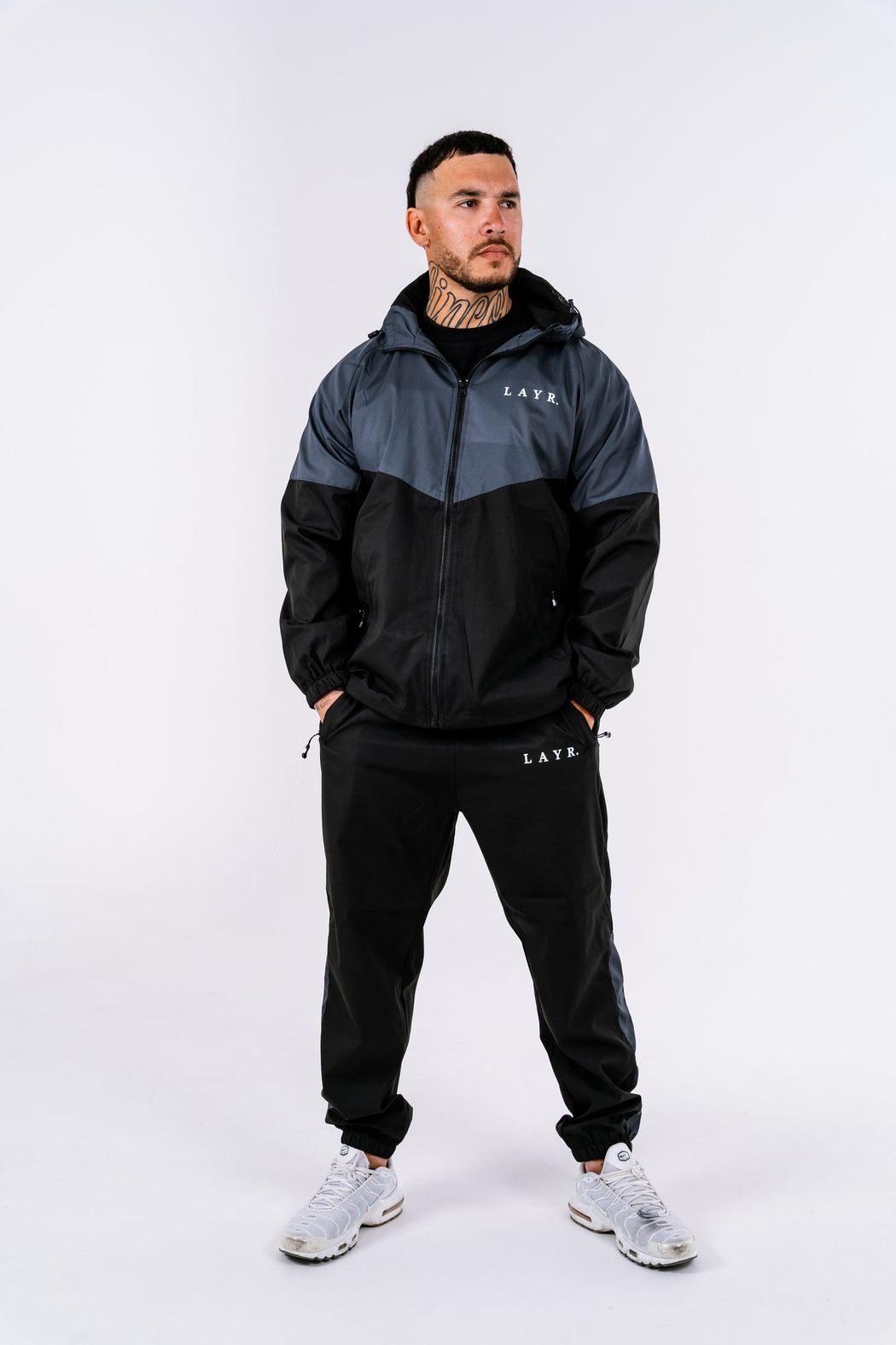 Man in a black and grey tracksuit