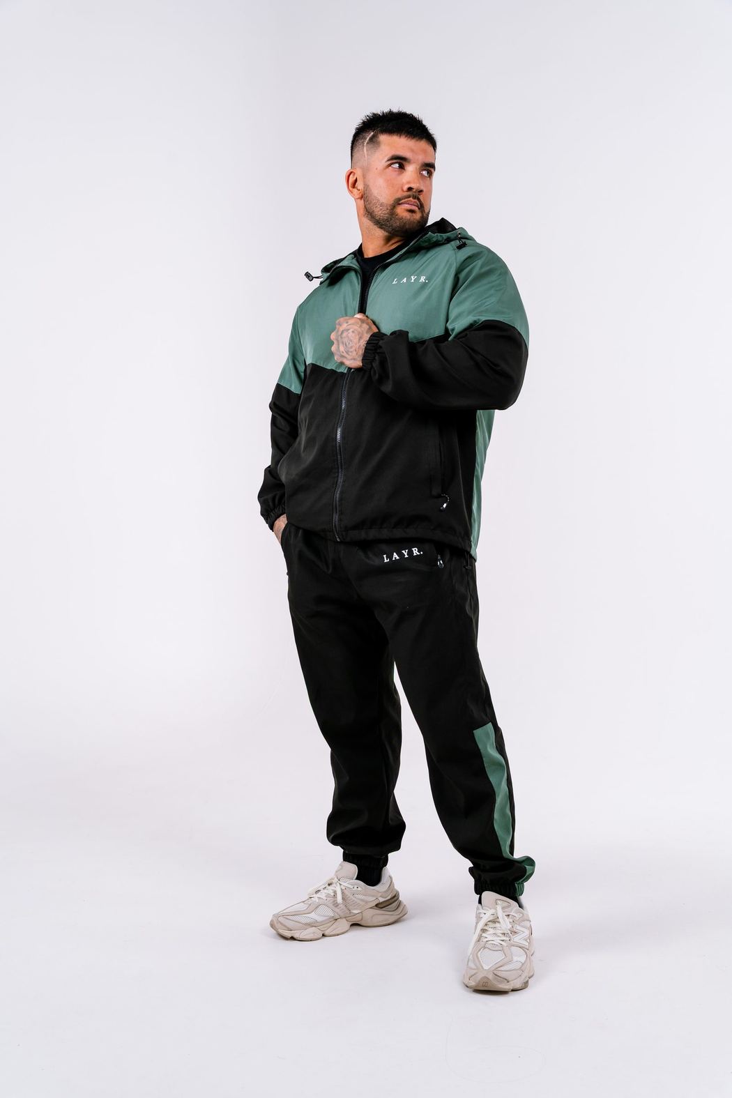 Man in a green and black windbreaker