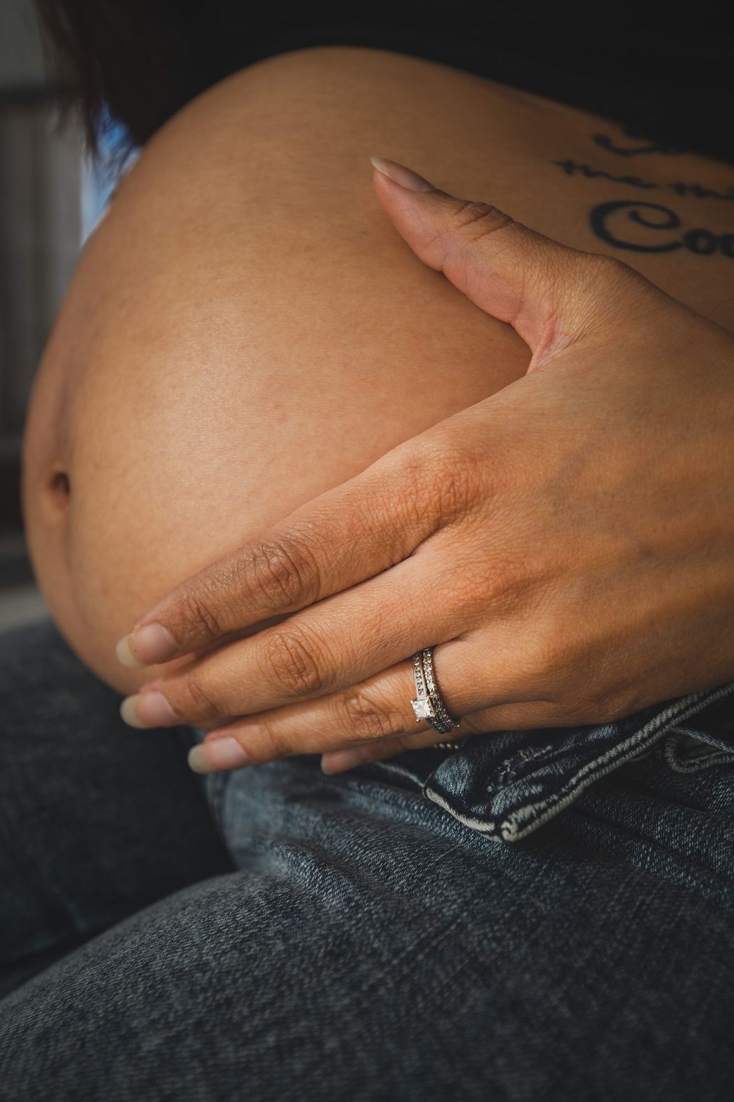 Close detail of hands on a pregnant belly