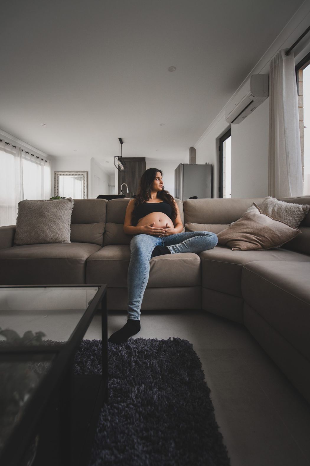 Expecting mother seated on a sofa in a quiet living room